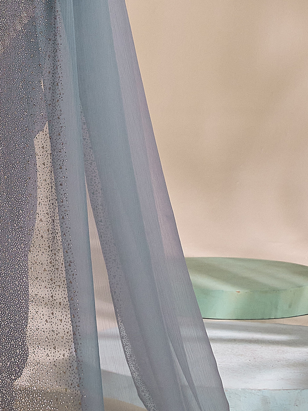 Pallu detail of light blue chiffon saree showing ornamented surface design and embellished border