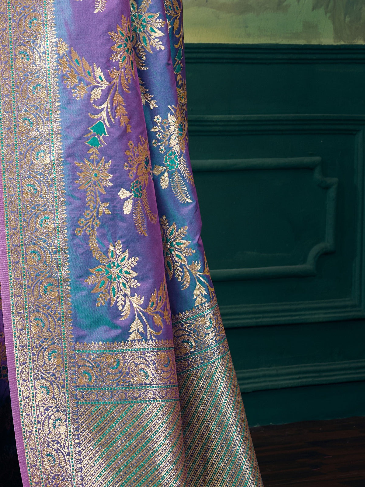 Pallu detail of teal blue banarasi silk saree showing woven motif design and zari border