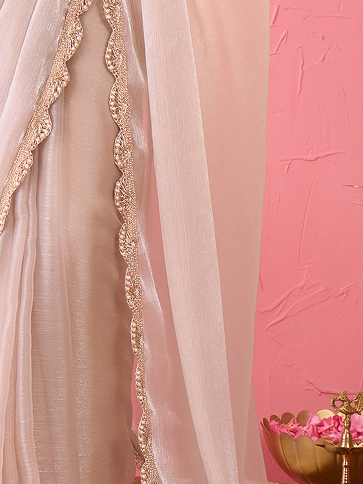 Pallu detail of cream organza saree showing clean solid-tone finish and embellished border