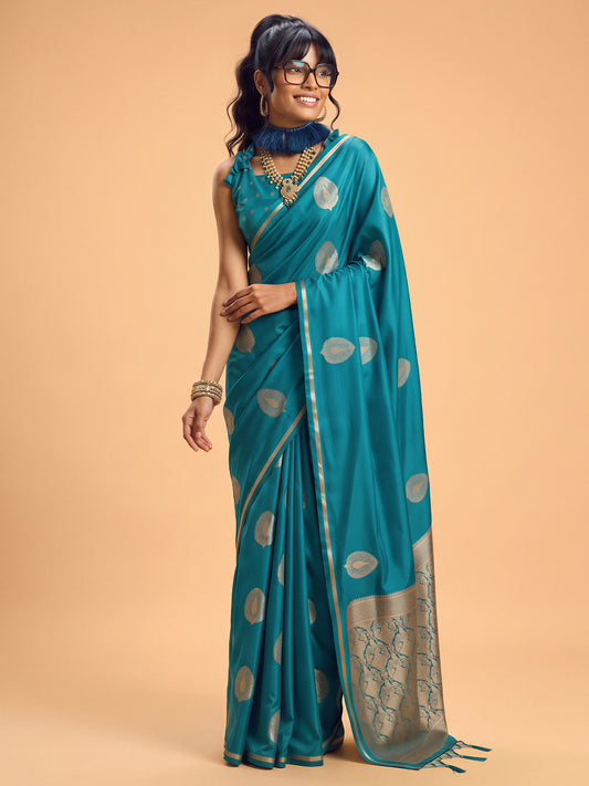 Woman wearing light blue satin silk saree with zari butta (metallic motif) work and light blue blouse