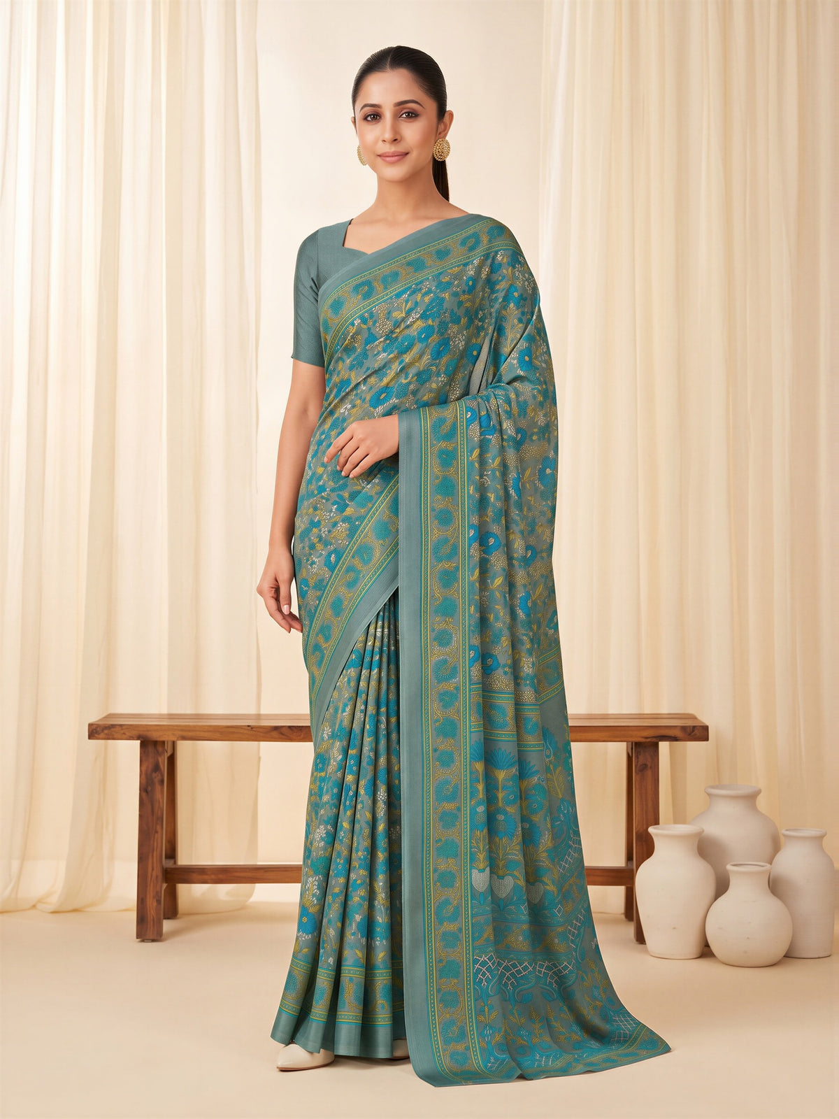 Woman wearing grey crepe saree with all-over floral design and grey blouse