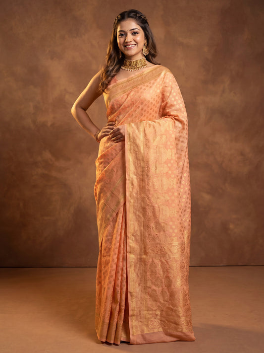 Woman wearing orange silk blend saree with zari butta (metallic motif) work and orange blouse