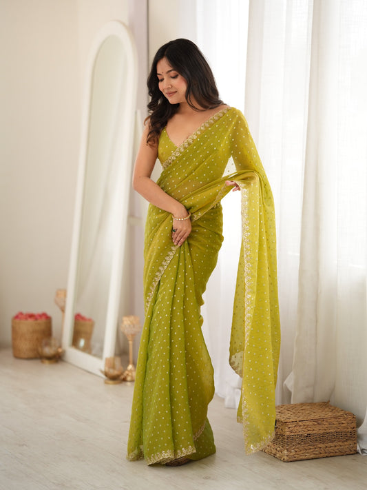 Woman wearing lime green georgette saree with zari butta (metallic motif) work and lime green blouse