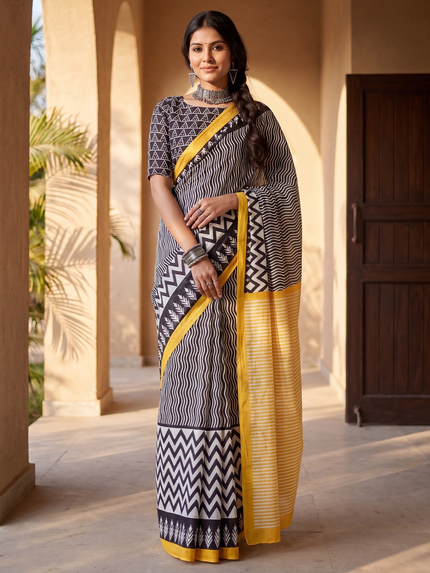 Woman wearing black cotton blend saree with leheriya design and black blouse