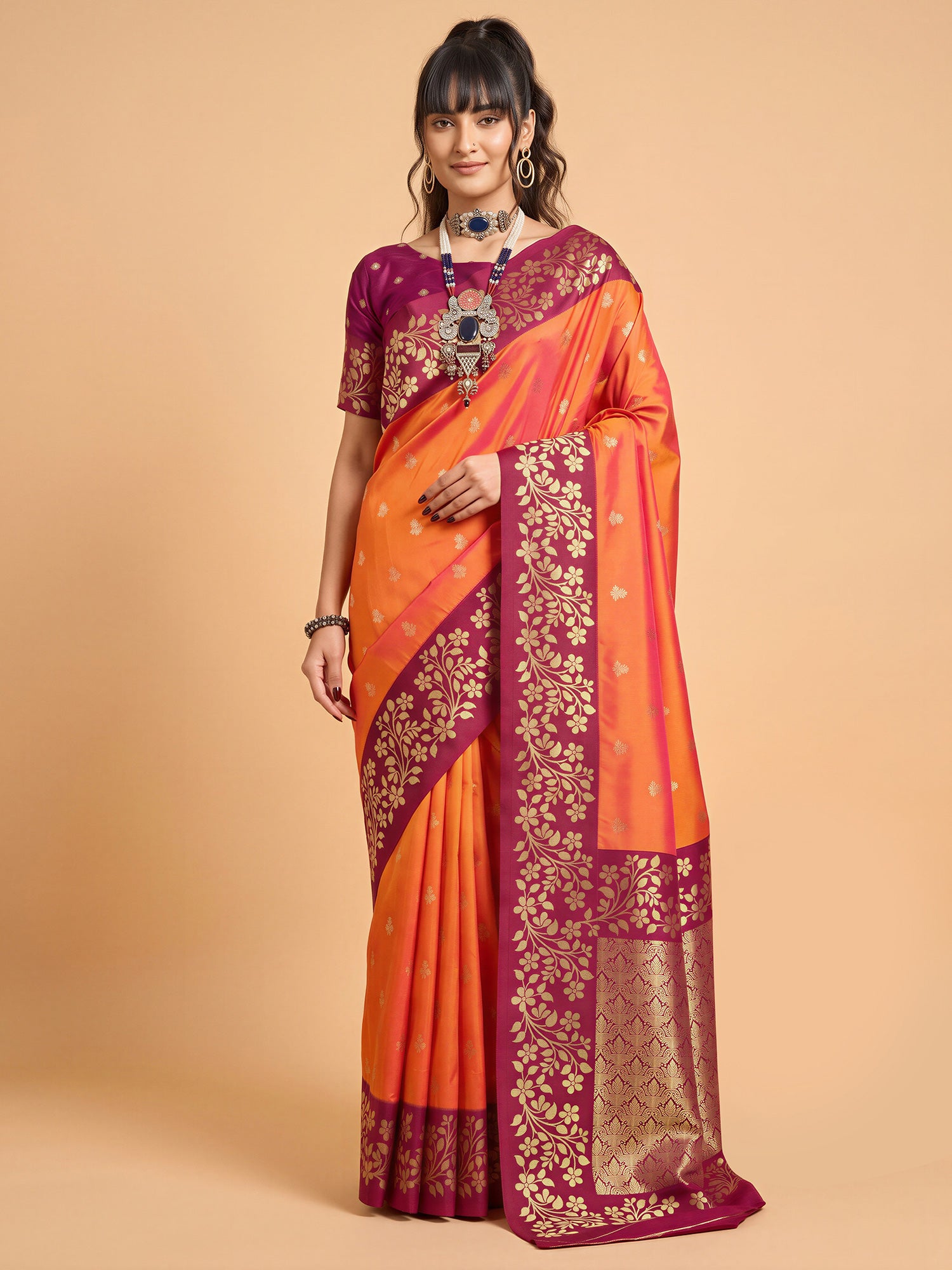 Woman wearing orange cotton blend saree with all-over floral design and magenta blouse