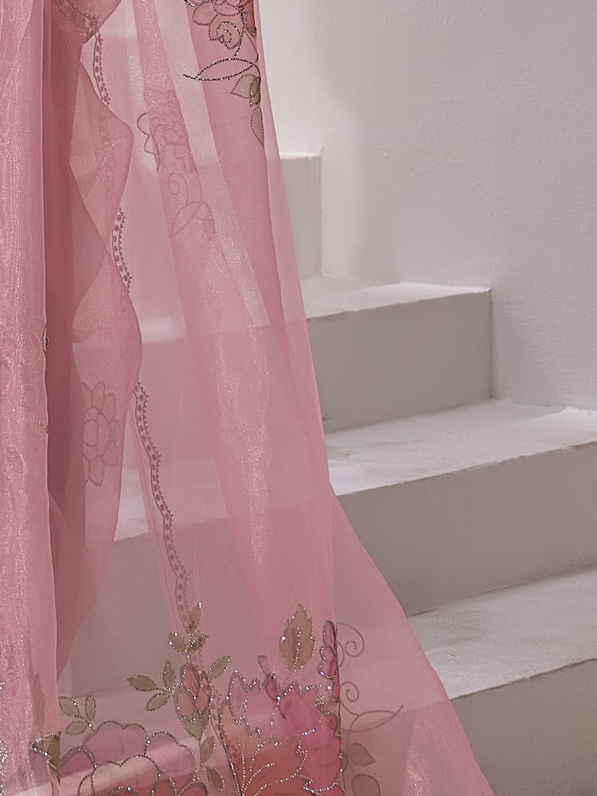 Pallu detail of pink organza saree showing ornamented surface design and embellished border