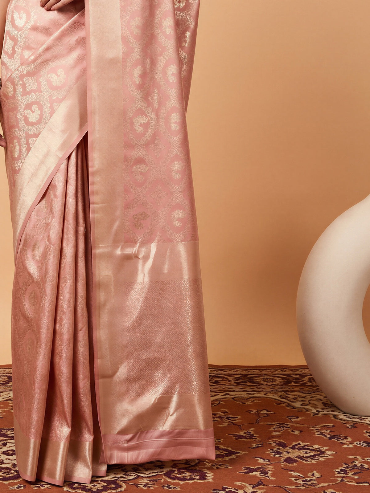 Pallu detail of peach silk blend saree showing woven motif design and zari border