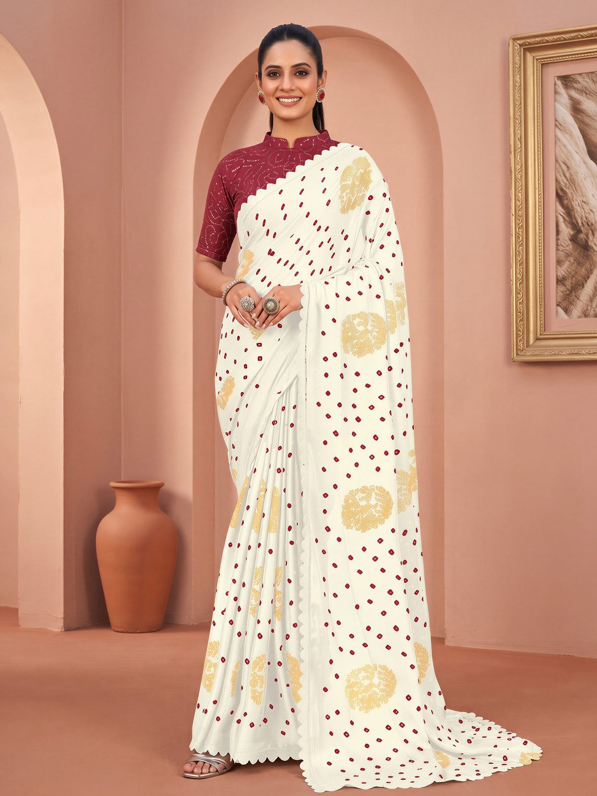 Woman wearing white chiffon saree with bandhani tie-dye dot work and magenta blouse
