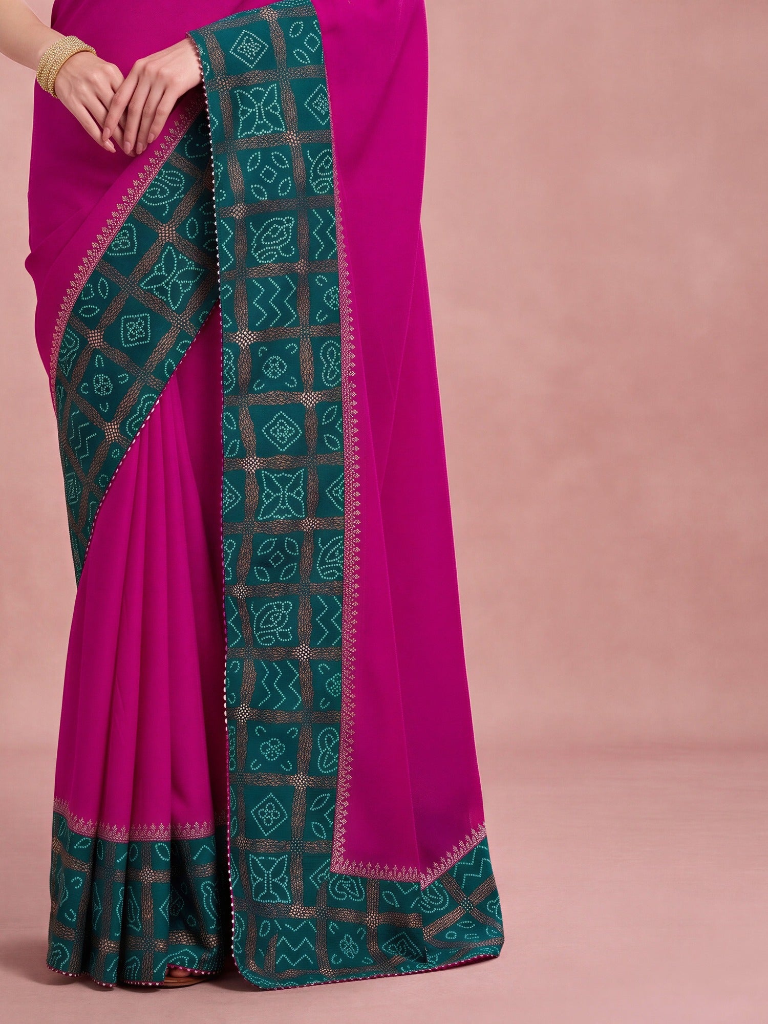 Pallu detail of magenta vichitra silk saree showing bandhani tie-dye dot work and embellished border