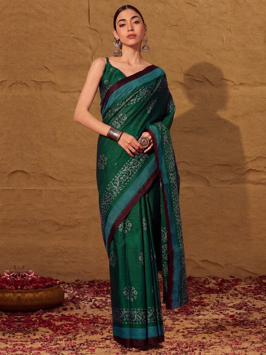 Woman wearing green cotton saree with batik wax-resist design and green blouse