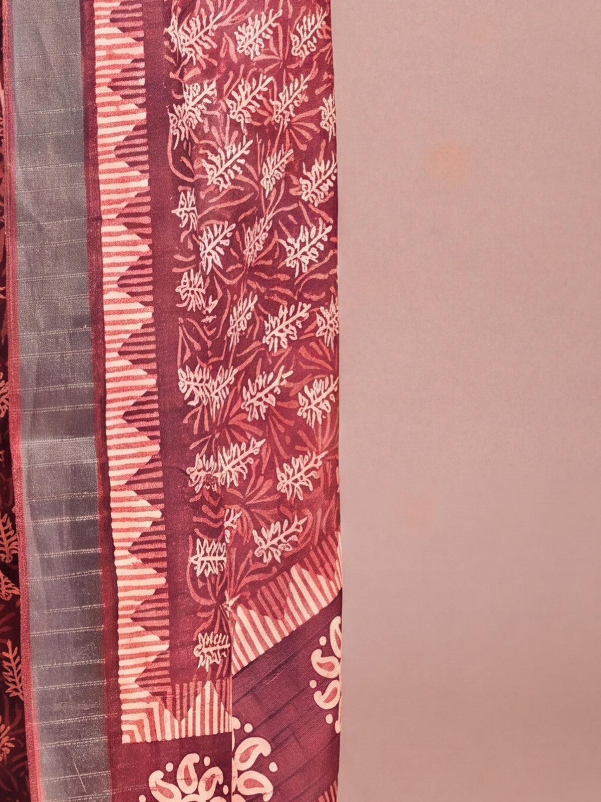 Pallu detail of brown cotton silk saree showing traditional indian motif work and zari border