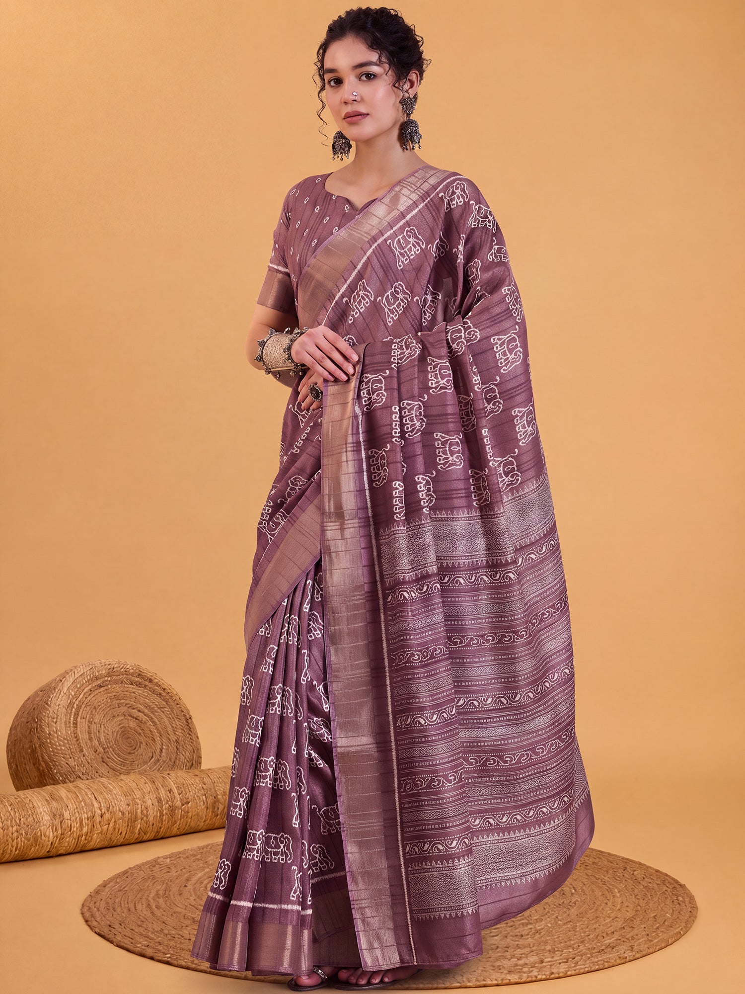 Woman wearing mauve silk blend saree with hand block-printed motifs and mauve blouse