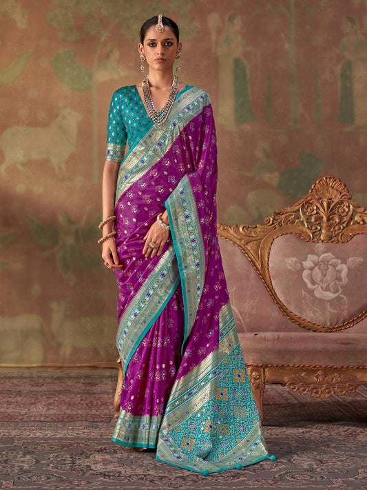 Woman wearing purple silk blend saree with traditional indian motif work and turquoise blue blouse
