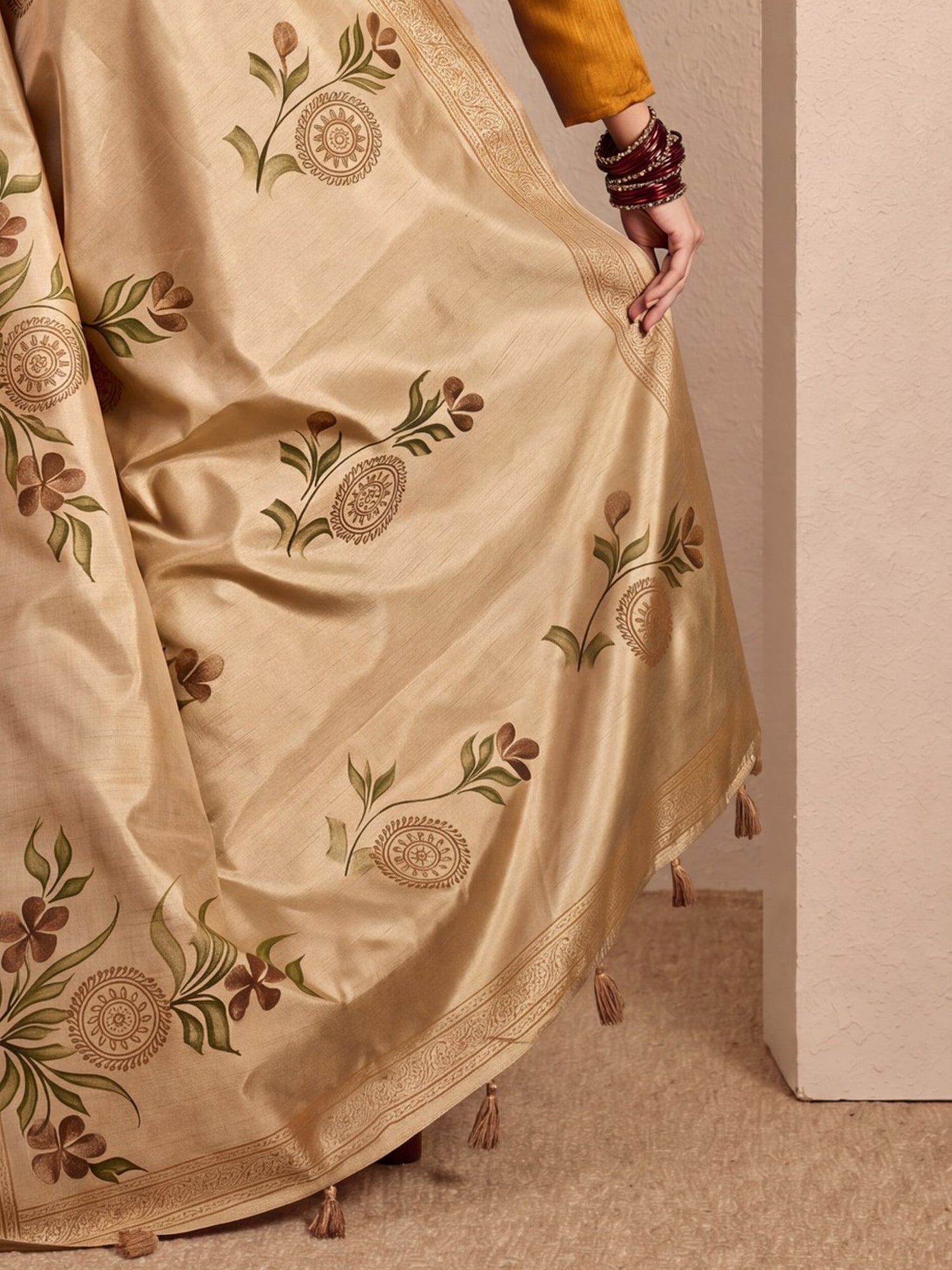 Pallu detail of beige silk blend saree showing hand-painted motif work and printed border