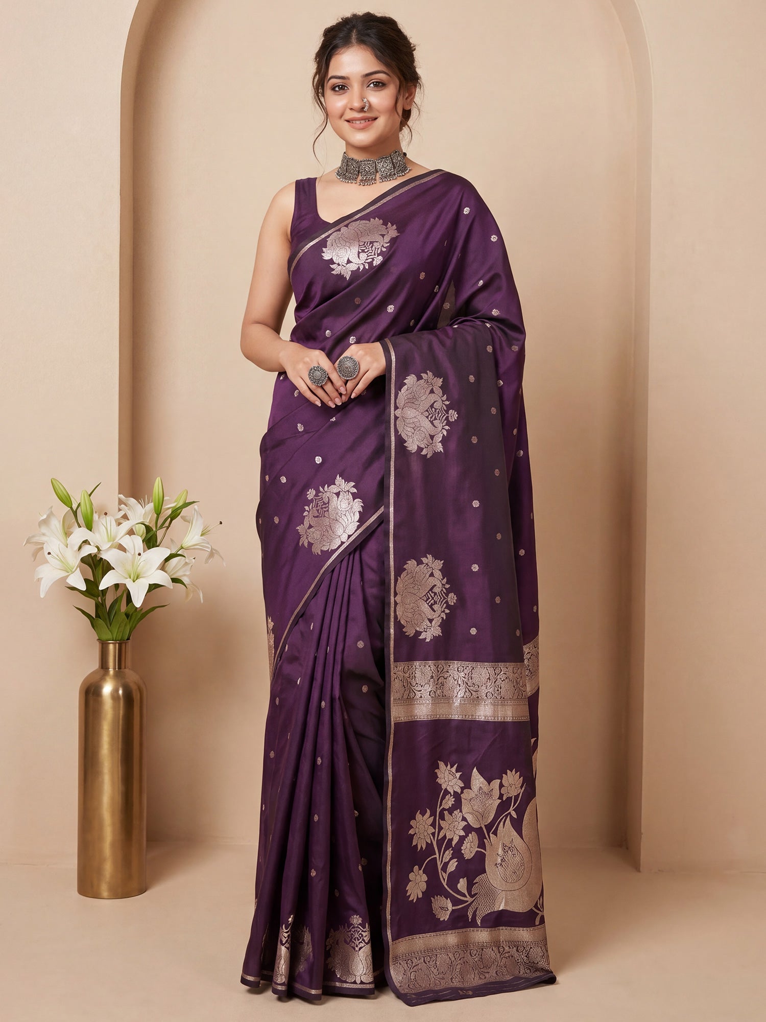 Woman wearing wine silk blend saree with zari butta (metallic motif) work and wine blouse
