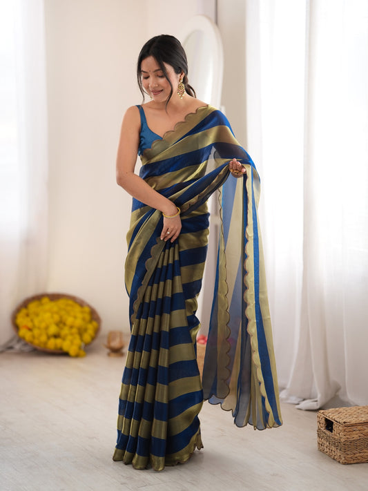 Woman wearing teal blue satin saree with striped pattern design and teal blue blouse