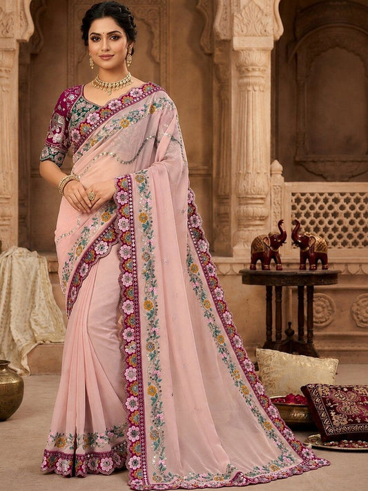 Woman wearing pink pure georgette saree with all-over floral design and pink blouse