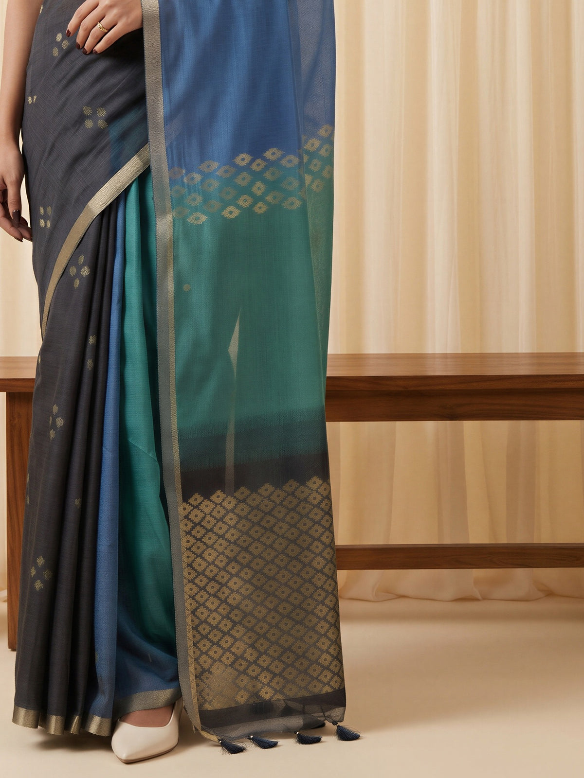 Pallu detail of black viscose silk saree showing traditional indian motif work and solid border