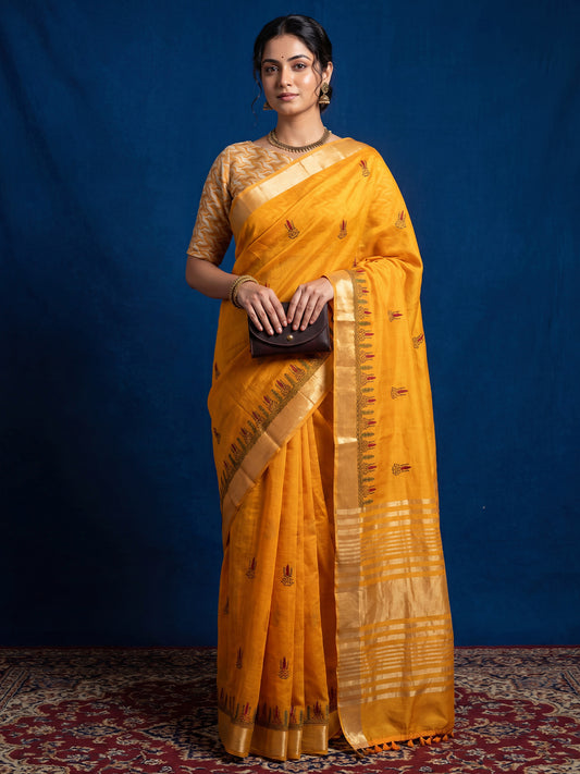 Woman wearing mustard cotton linen saree with embroidered motif work and mustard blouse