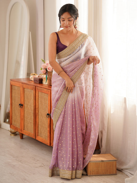 Woman wearing lavender silk blend saree with zari butta (metallic motif) work and lavender blouse