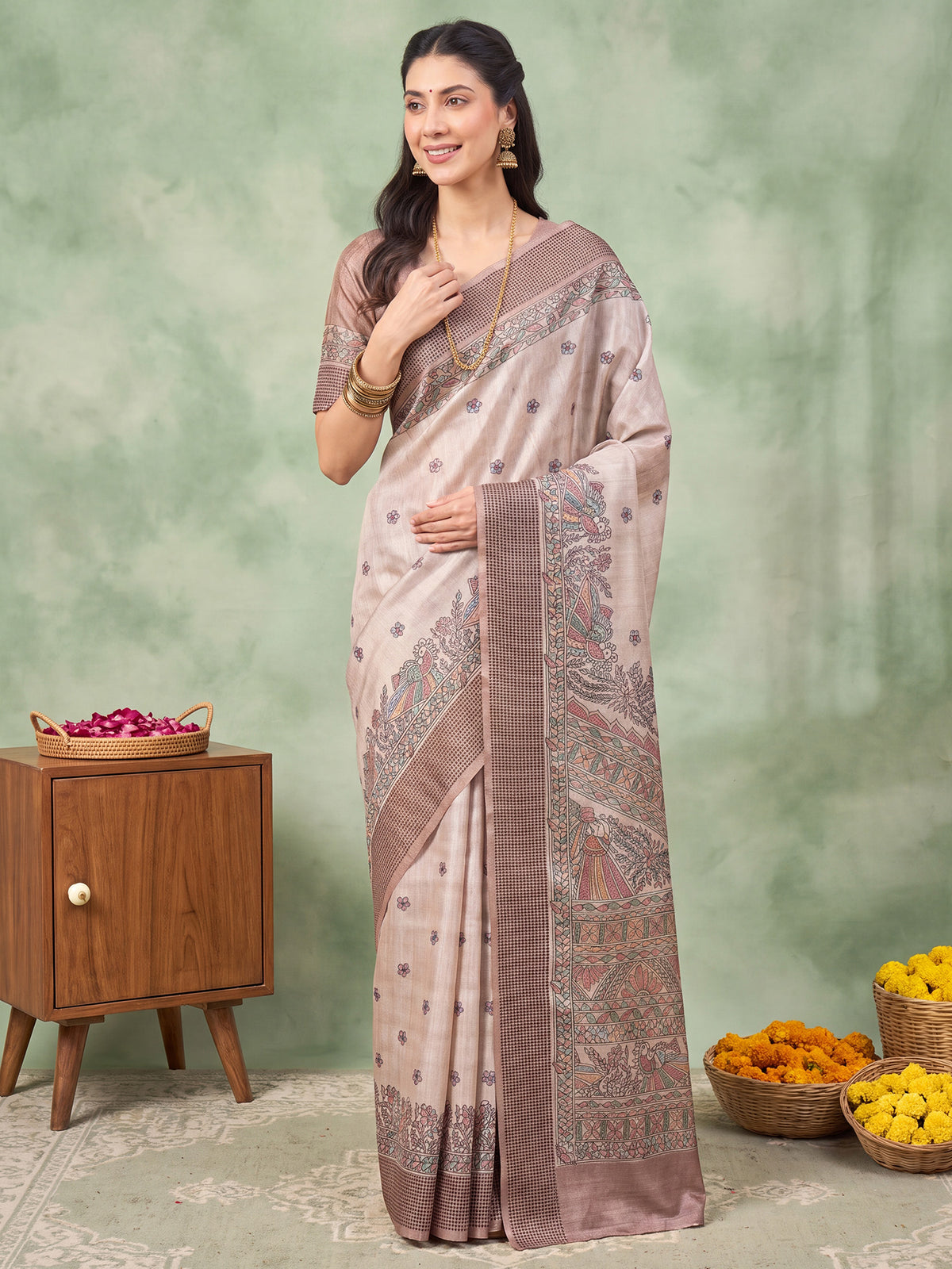 Woman wearing beige manipuri silk saree with madhubani folk-art motifs and beige blouse