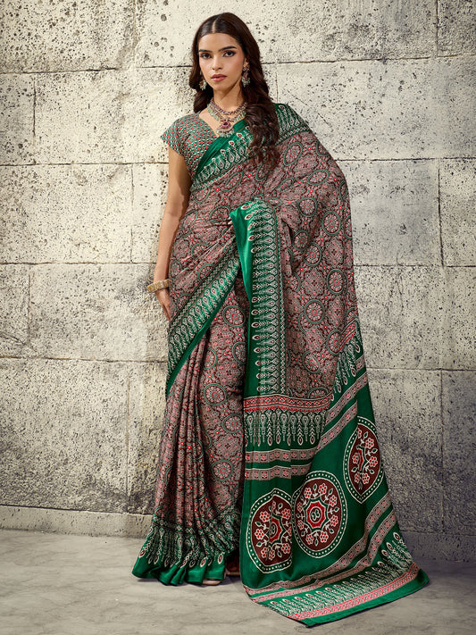 Woman wearing green satin saree with ajrak block-print motif work and green blouse