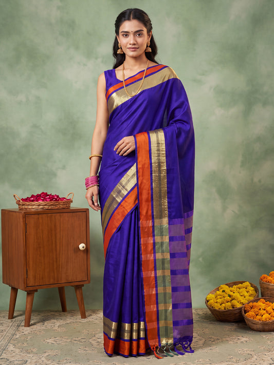 Woman wearing blue aura silk saree with clean solid-tone finish and blue blouse