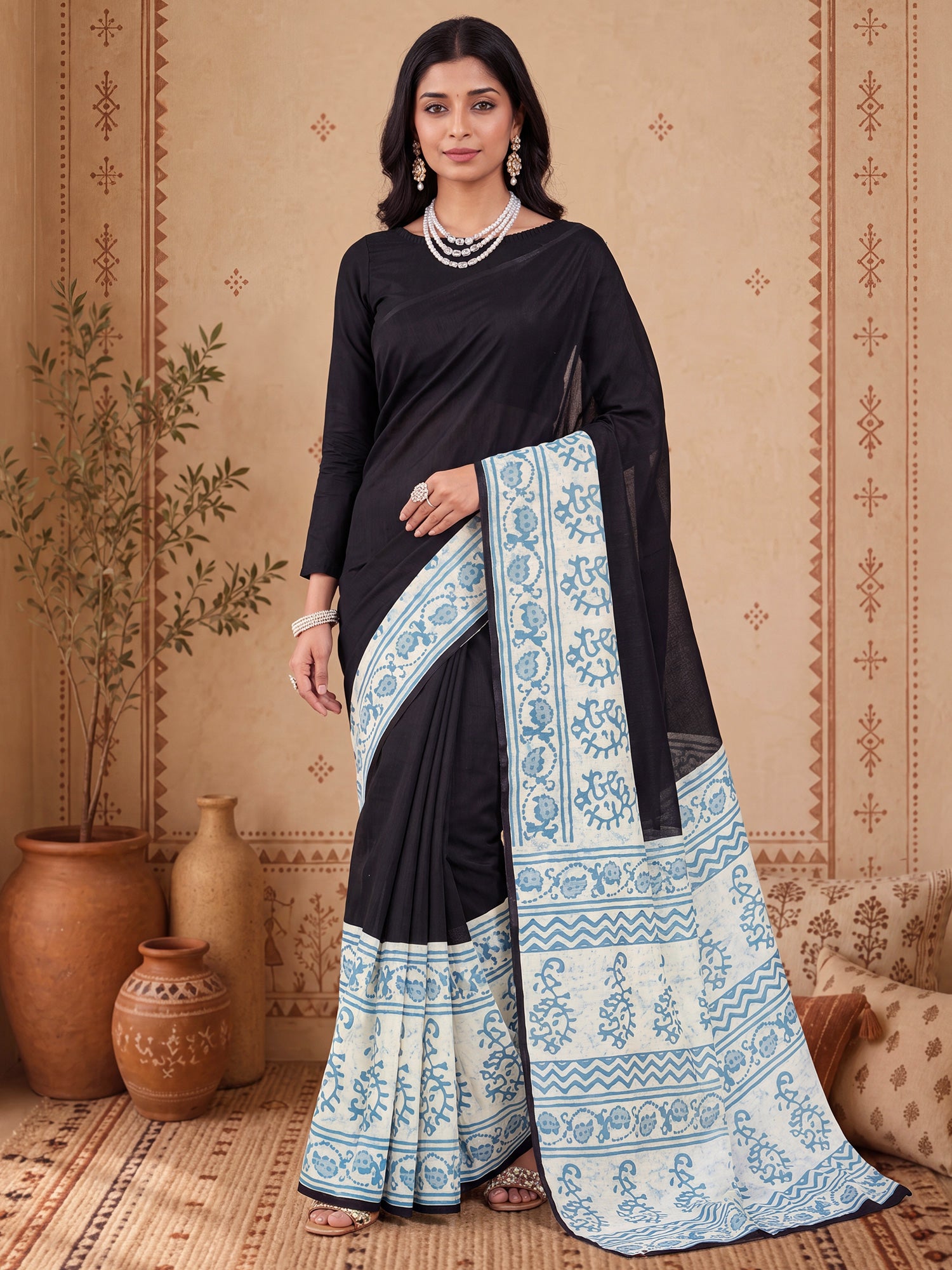 Woman wearing black bhagalpuri silk saree with traditional indian motif work and black blouse