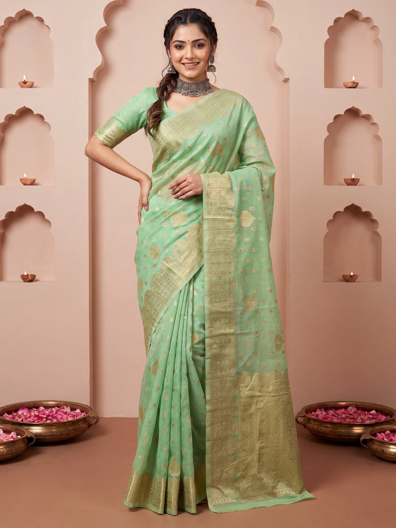 Woman wearing mint green silk blend saree with zari butta (metallic motif) work and mint green blouse