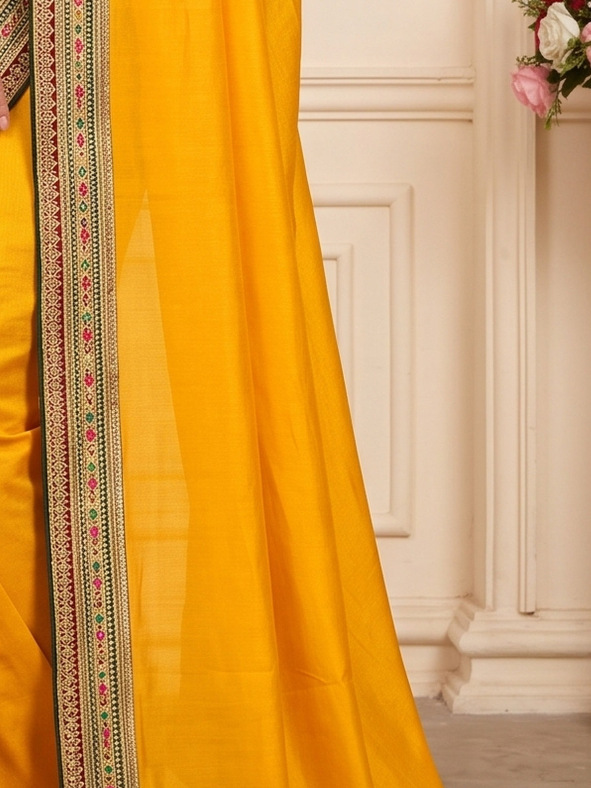 Pallu detail of mustard vichitra silk saree showing clean solid-tone finish and embellished border