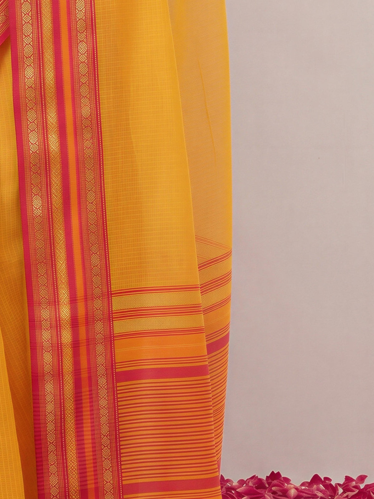 Pallu detail of mustard kota doria cotton saree showing clean solid-tone finish and zari border