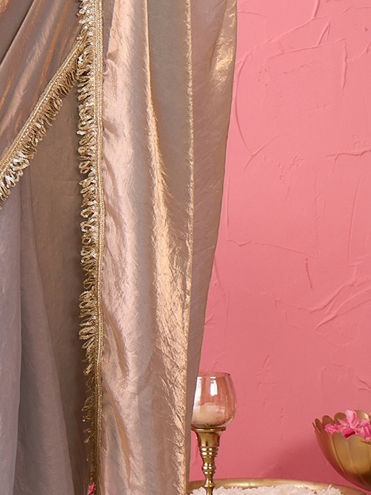 Pallu detail of metallic paper silk saree showing ornamented surface design and embellished border