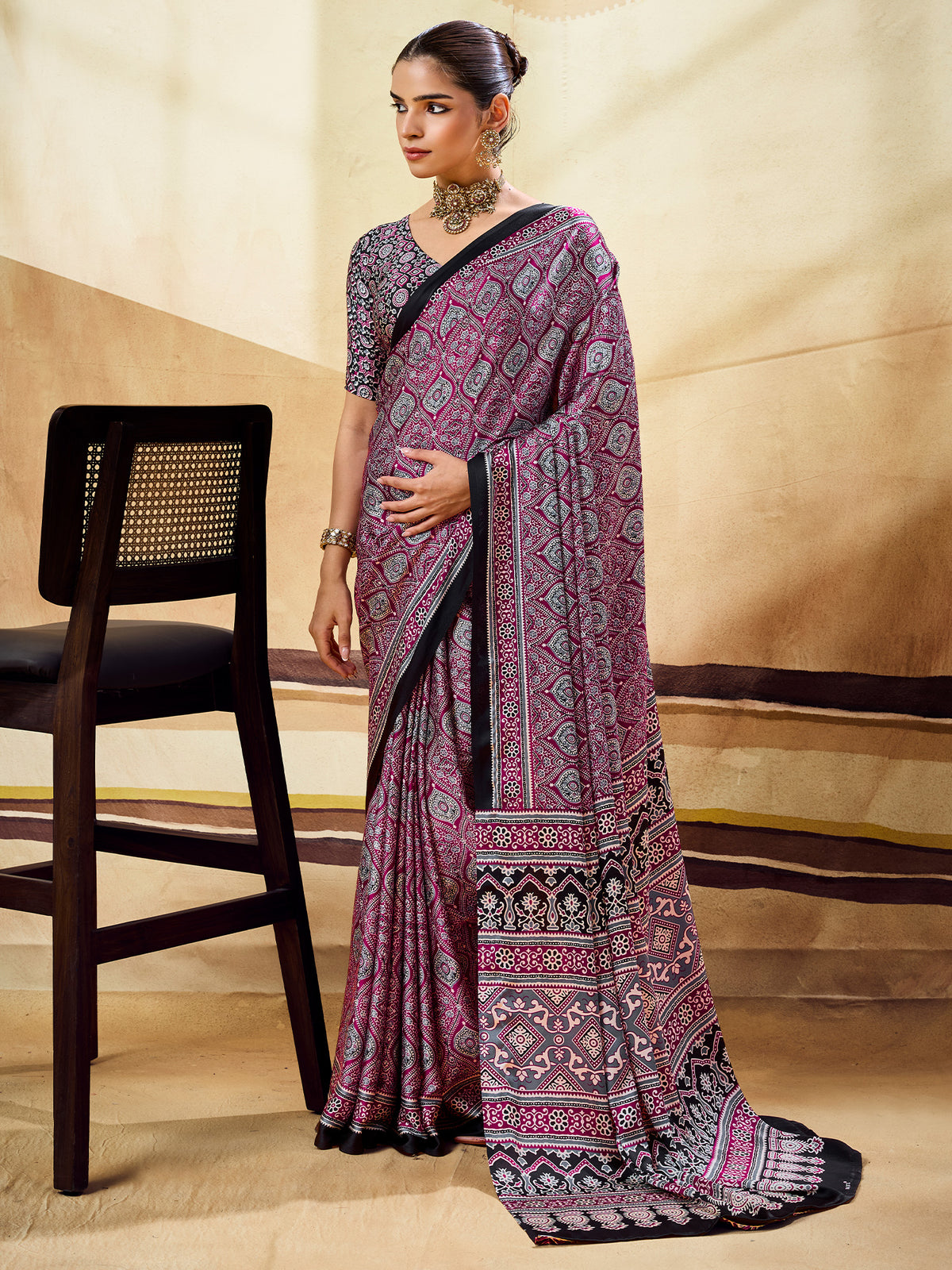 Woman wearing magenta satin saree with ajrak block-print motif work and black blouse
