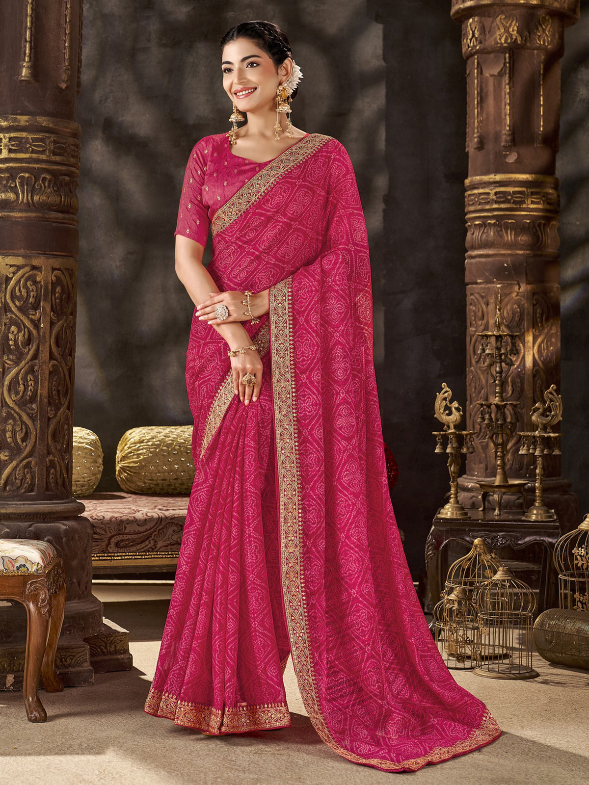 Woman wearing pink chiffon saree with bandhani tie-dye dot work and pink blouse