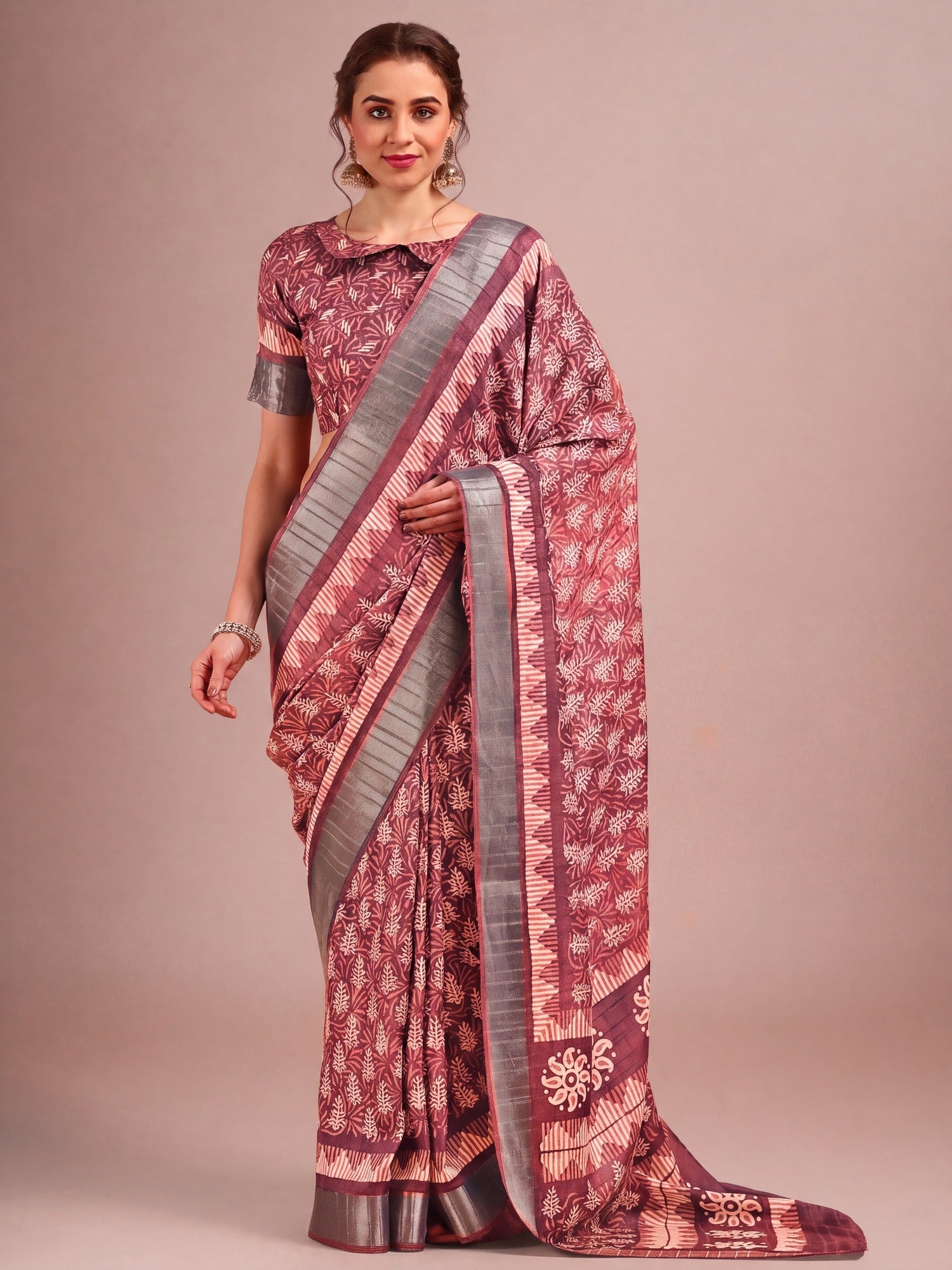 Woman wearing brown cotton silk saree with traditional indian motif work and brown blouse
