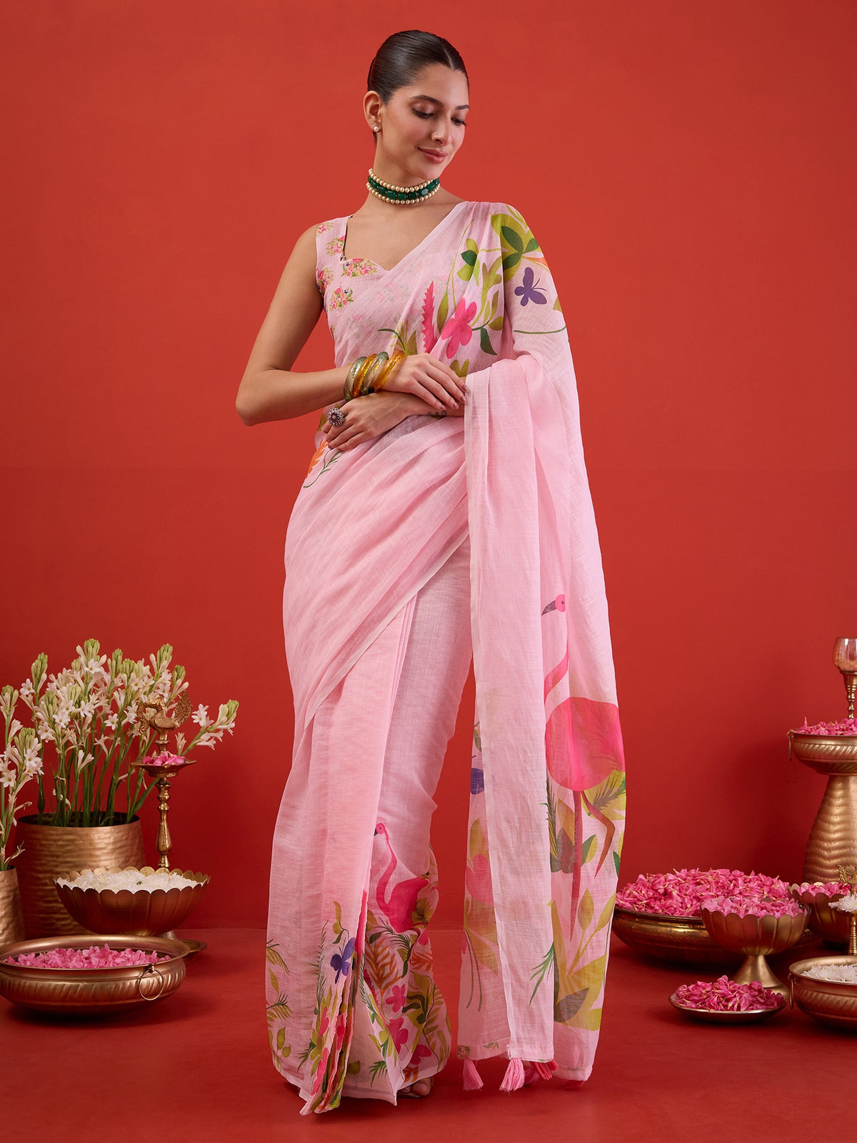 Woman wearing pink linen ready to wear saree with all-over floral design and pink blouse