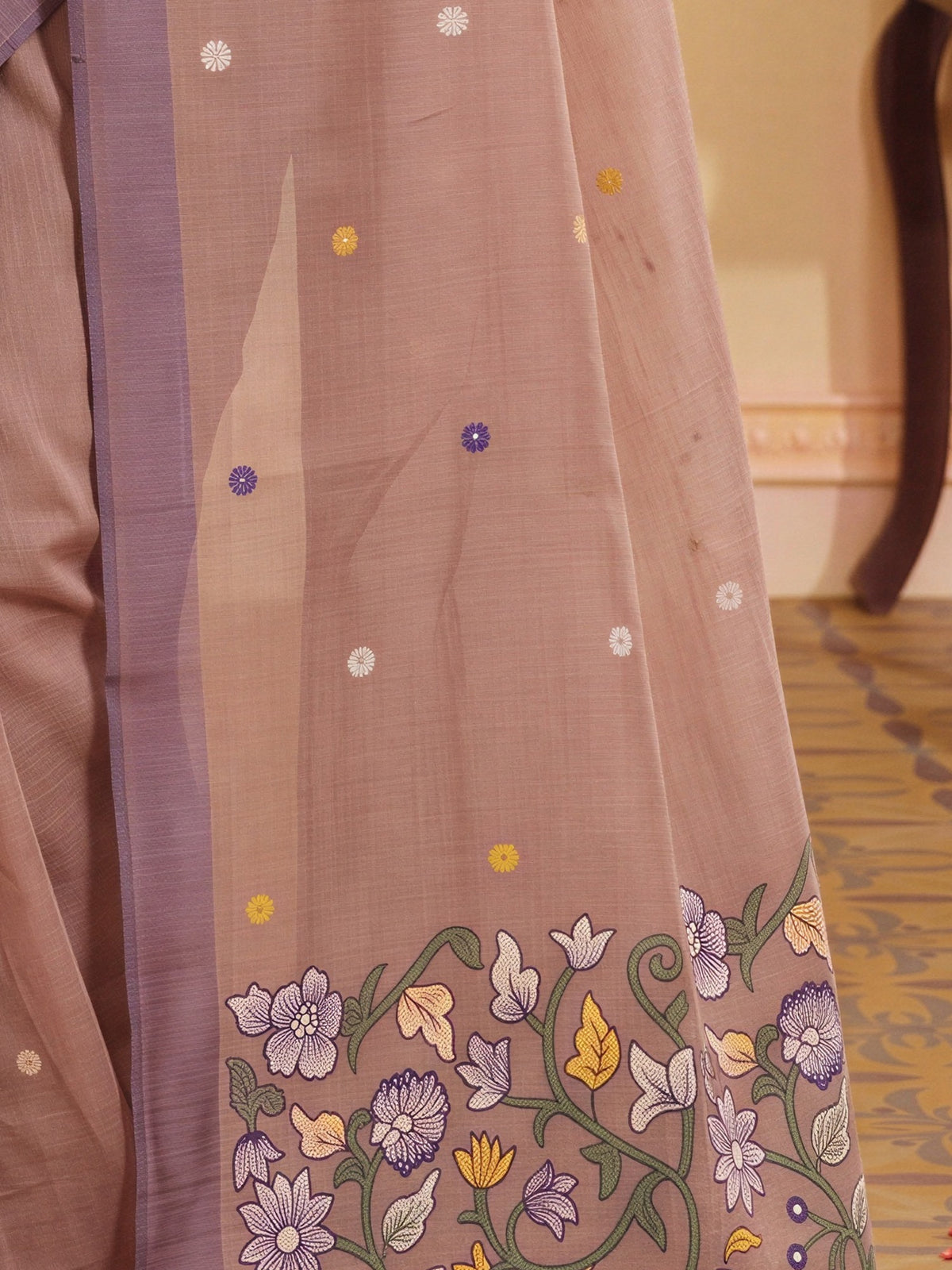 Pallu detail of light brown silk blend saree showing traditional indian motif work and woven design border