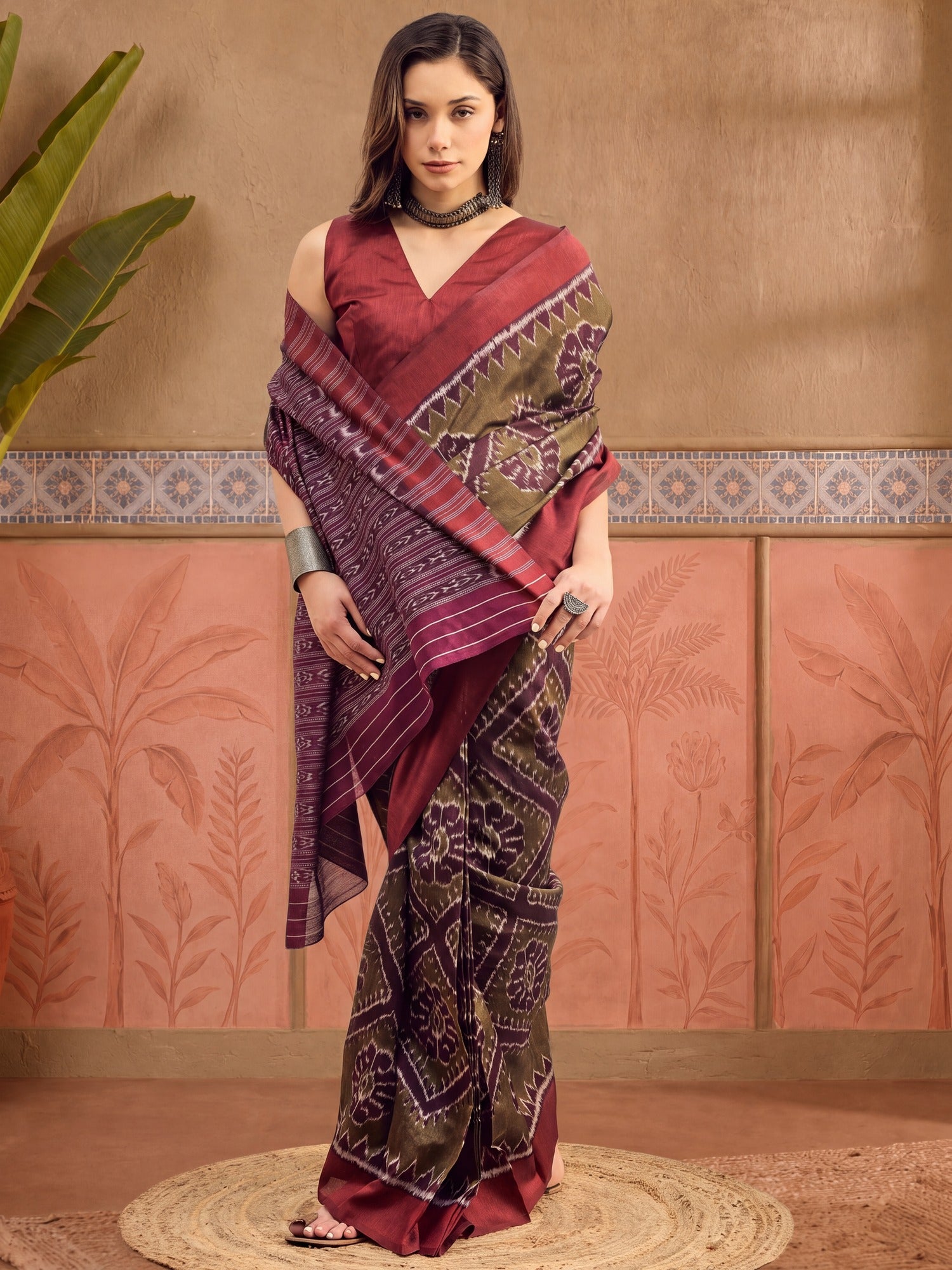 Woman wearing olive bhagalpuri silk saree with ikat resist-dyed pattern and maroon blouse