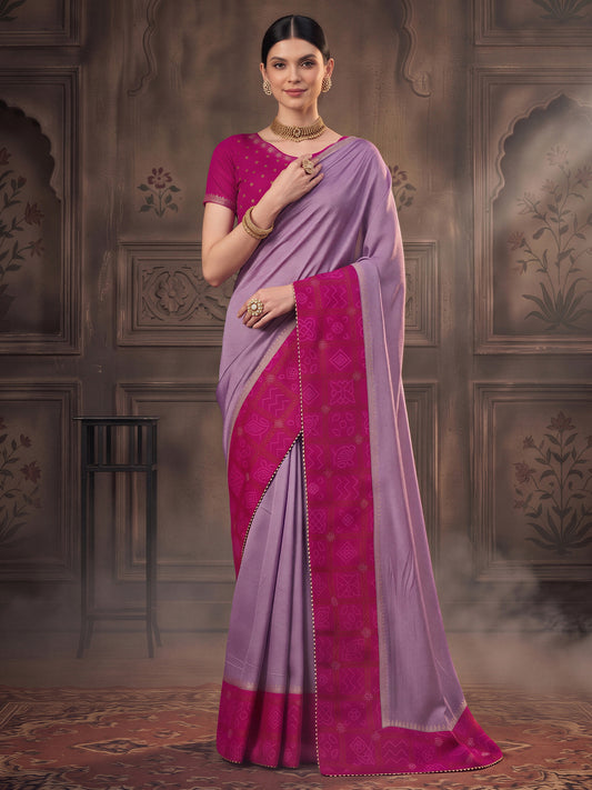 Woman wearing lavender vichitra silk saree with bandhani tie-dye dot work and pink blouse