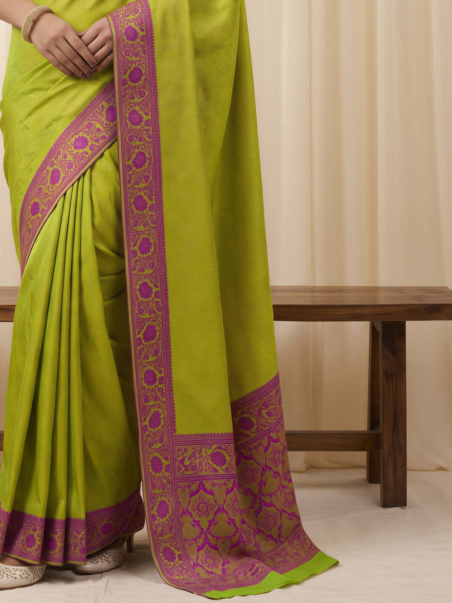 Pallu detail of lime green silk blend saree showing traditional indian motif work and woven design border