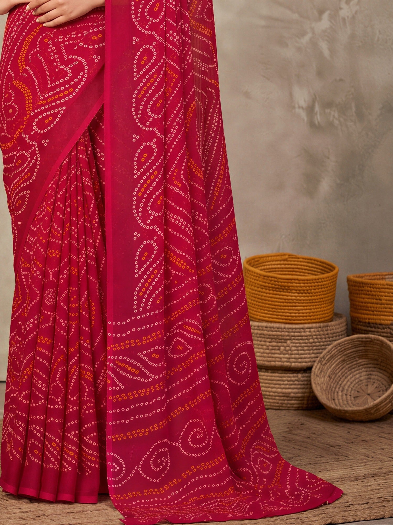 Pallu detail of pink chiffon saree showing bandhani tie-dye dot work and printed border