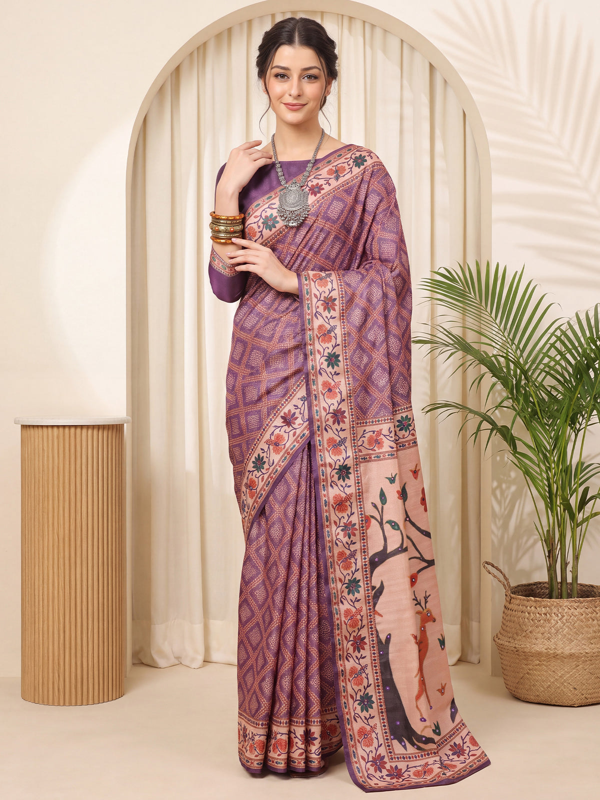 Woman wearing purple silk blend saree with traditional indian motif work and purple blouse