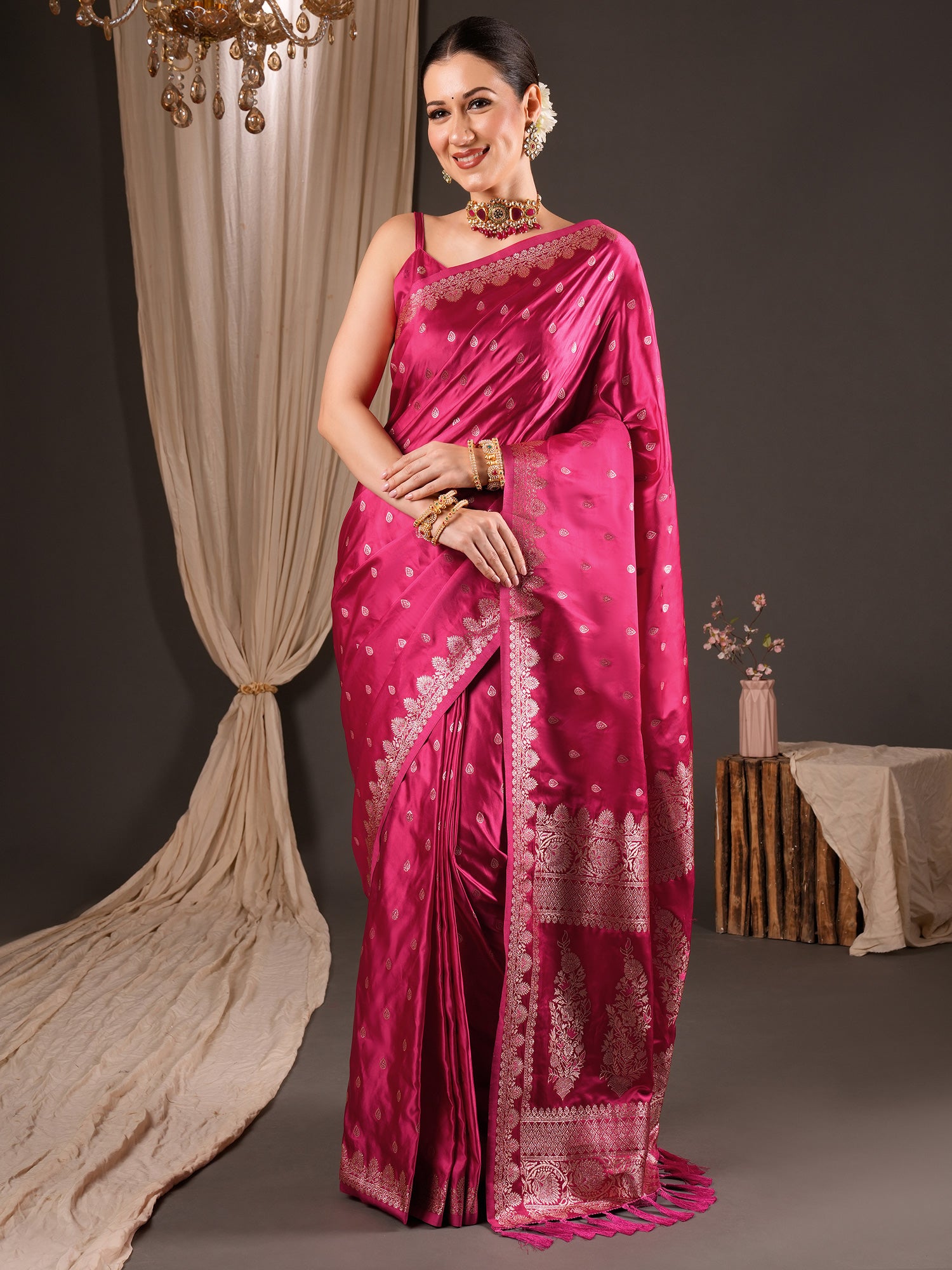 Woman wearing pink silk blend saree with zari butta (metallic motif) work and pink blouse