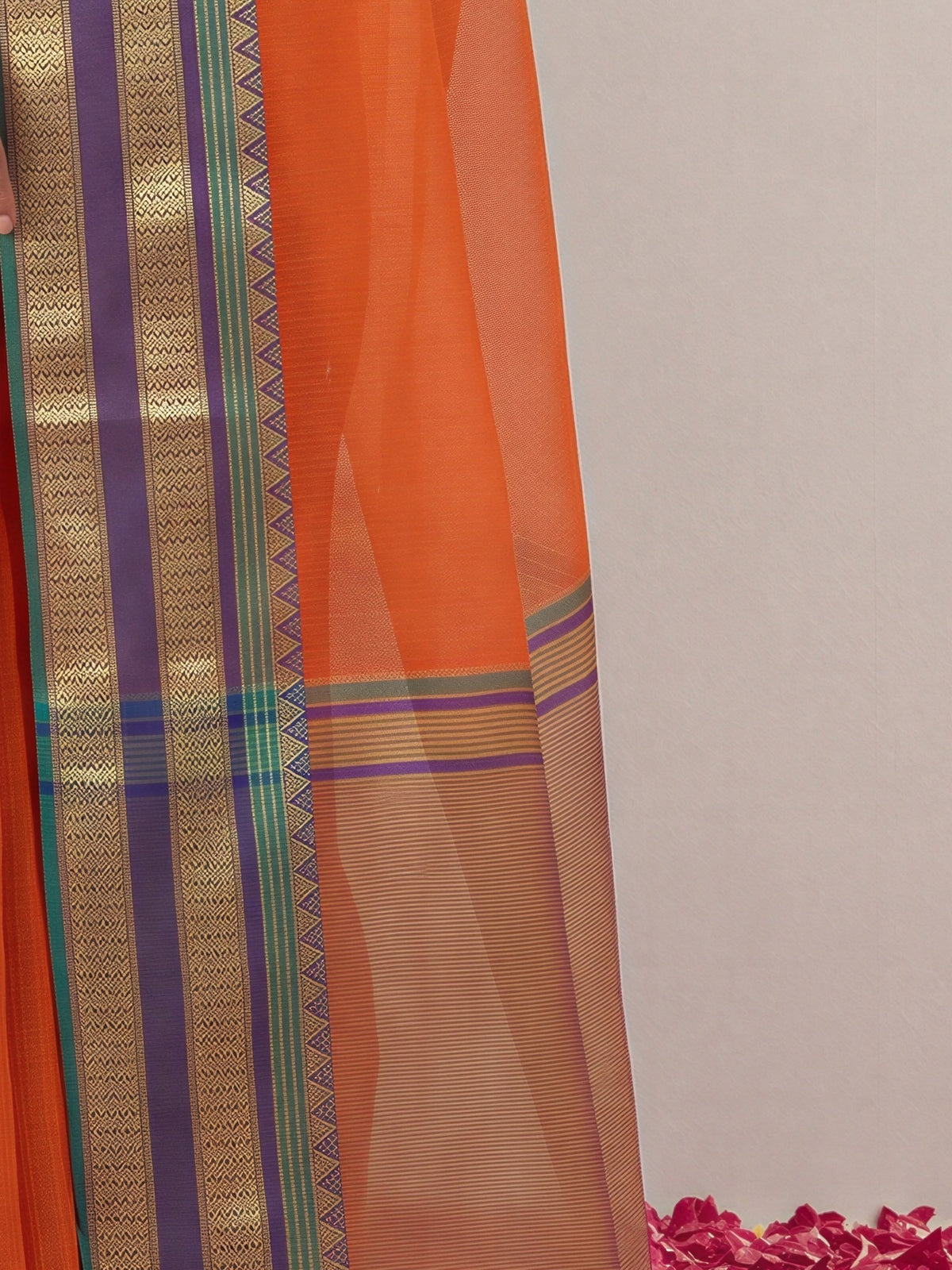 Pallu detail of orange kota doria cotton saree showing clean solid-tone finish and zari border