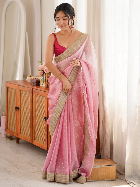 Woman wearing pink silk blend saree with zari butta (metallic motif) work and pink blouse