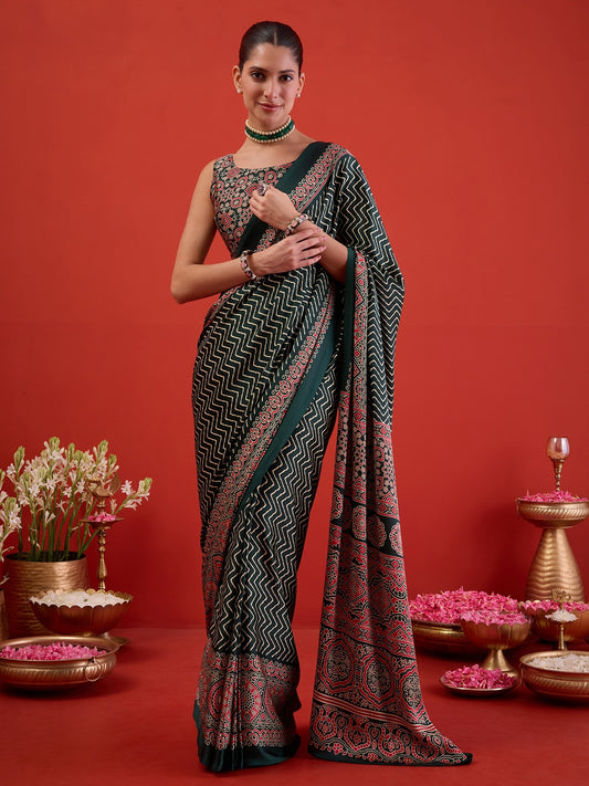 Woman wearing green satin ready to wear saree with chevron zigzag pattern and green blouse
