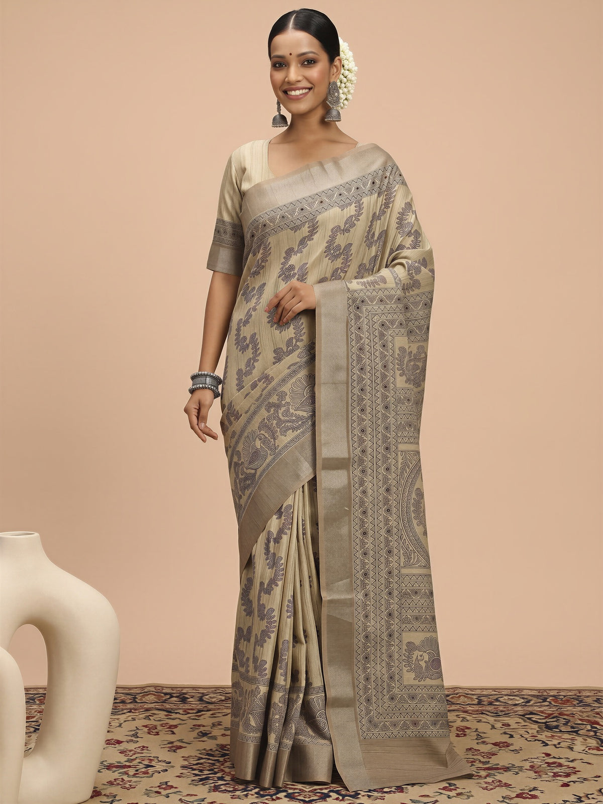 Woman wearing beige satin silk saree with hand block-printed motifs and beige blouse