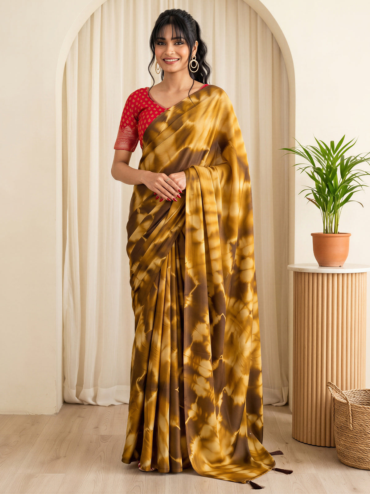 Woman wearing brown satin silk saree with tie-and-dye resist pattern and red blouse