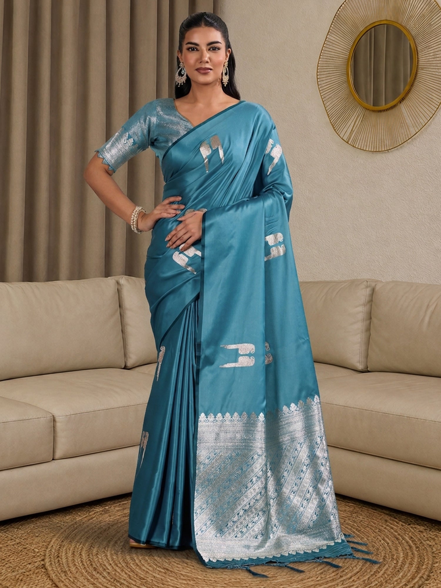 Woman wearing light blue satin saree with botanical floral and leaf design and light blue blouse