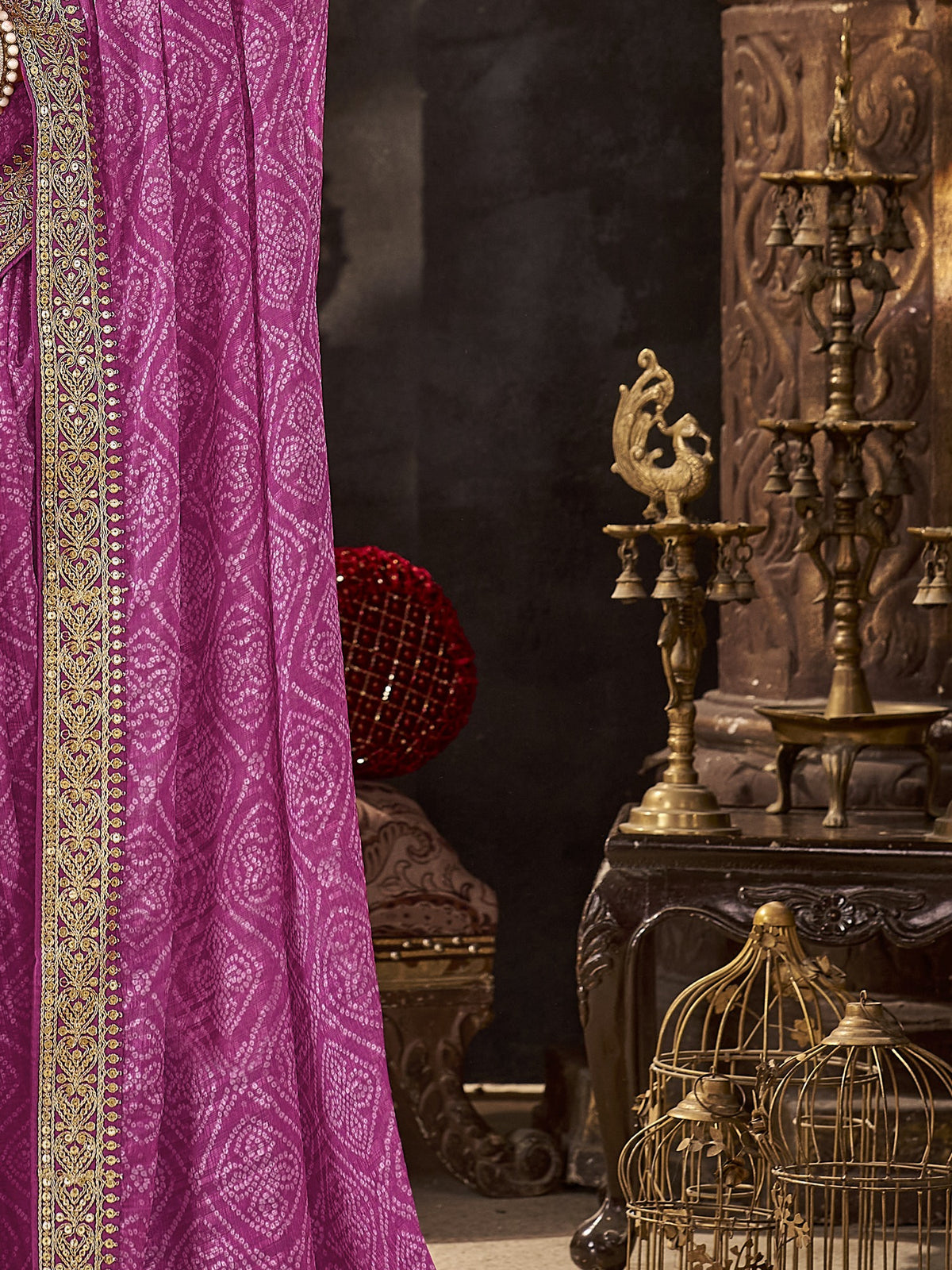 Pallu detail of magenta chiffon saree showing bandhani tie-dye dot work and embellished border